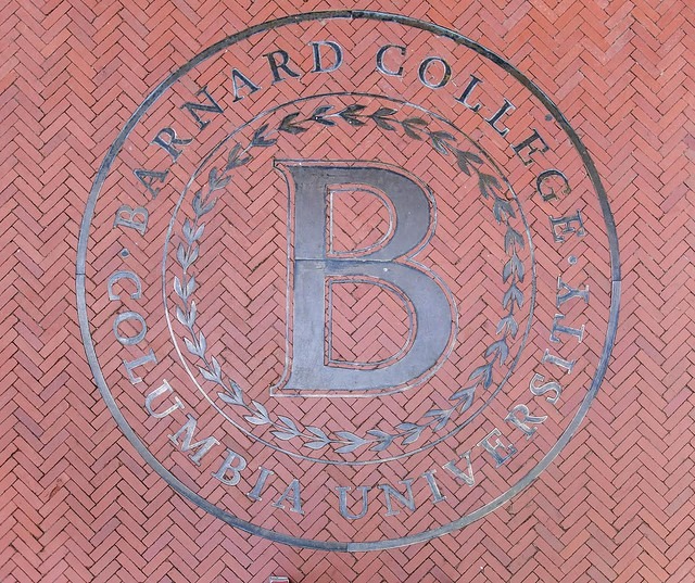 Barnard College emblem inset into red tile flooring.